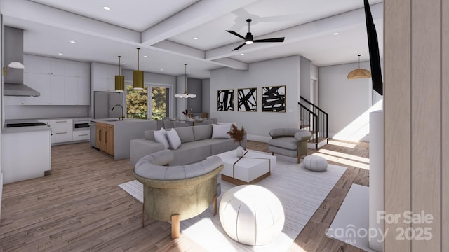 living area featuring ceiling fan, recessed lighting, stairs, light wood-type flooring, and beam ceiling