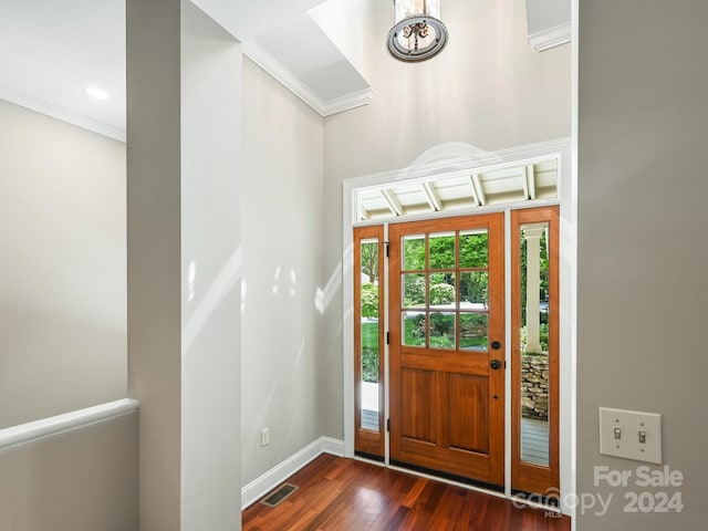 entrance foyer featuring dark hardwood / wood-style flooring and crown molding