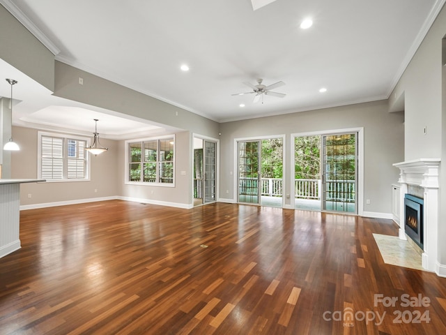 unfurnished living room with ornamental molding and dark wood-type flooring