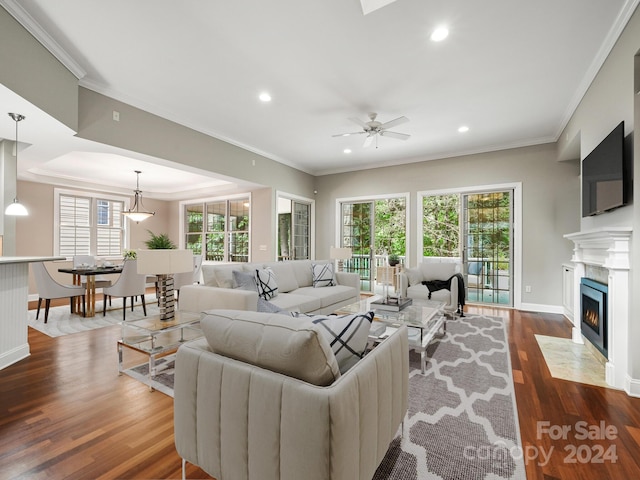 living room featuring crown molding, ceiling fan, and dark hardwood / wood-style floors