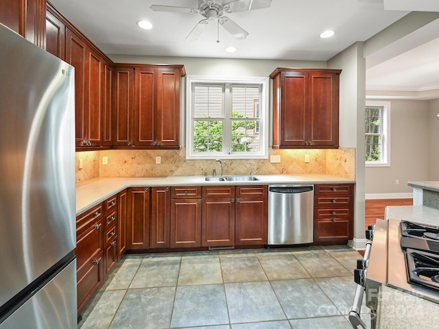 kitchen featuring appliances with stainless steel finishes, backsplash, ornamental molding, and sink