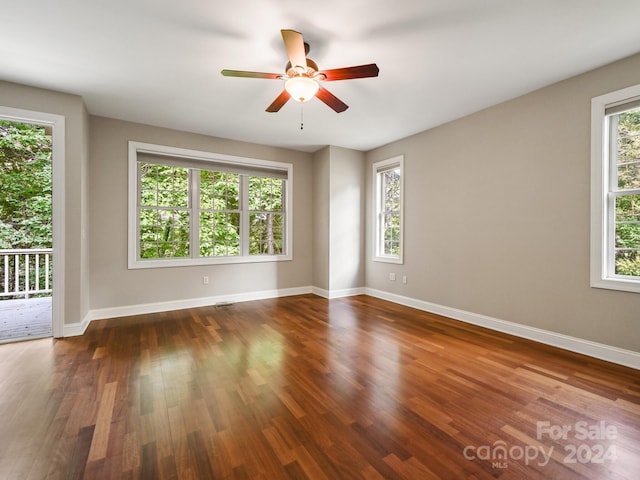 spare room featuring ceiling fan and dark wood-type flooring