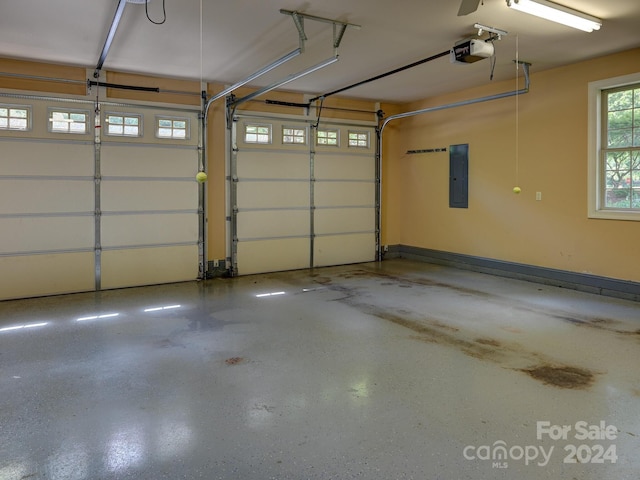 garage featuring electric panel and a garage door opener