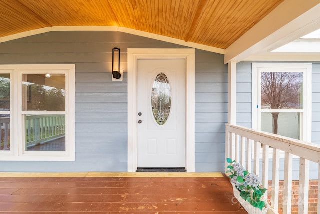 view of exterior entry with a porch