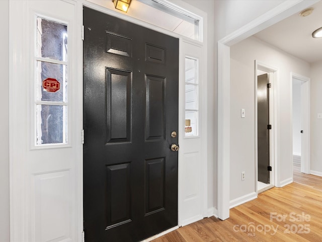 entrance foyer featuring wood-type flooring and plenty of natural light