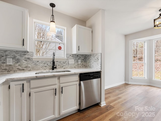 kitchen featuring sink, tasteful backsplash, decorative light fixtures, dishwasher, and white cabinets