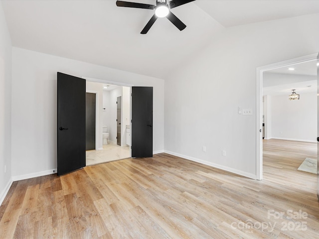 spare room with vaulted ceiling, light hardwood / wood-style floors, and ceiling fan