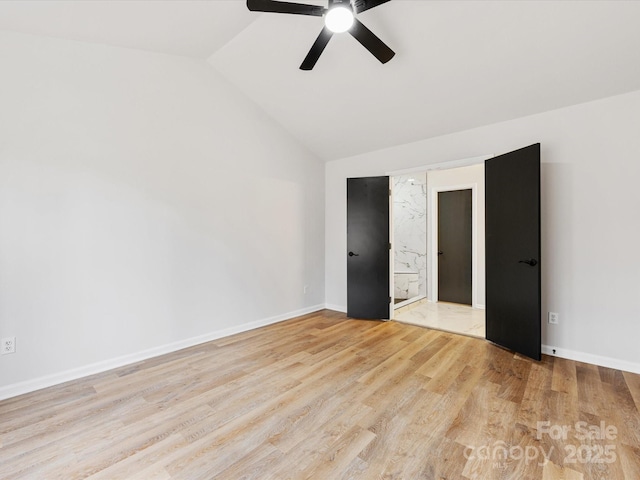 unfurnished bedroom with ceiling fan, lofted ceiling, and light hardwood / wood-style flooring