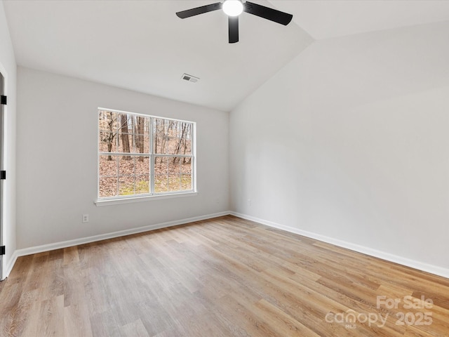 empty room featuring vaulted ceiling, ceiling fan, and light wood-type flooring