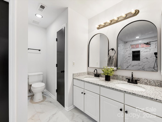 bathroom with vanity, a shower, and toilet