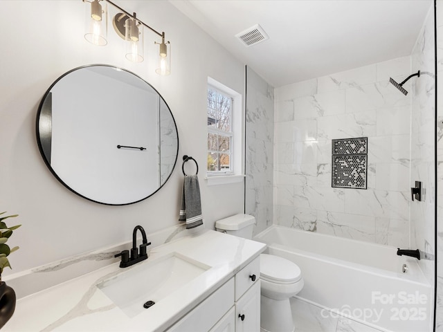 full bathroom with vanity, tiled shower / bath combo, and toilet