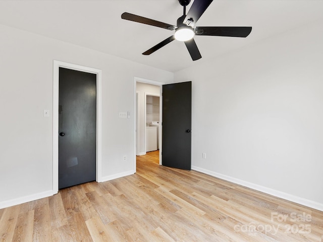 unfurnished bedroom featuring ceiling fan, washer / clothes dryer, and light hardwood / wood-style flooring