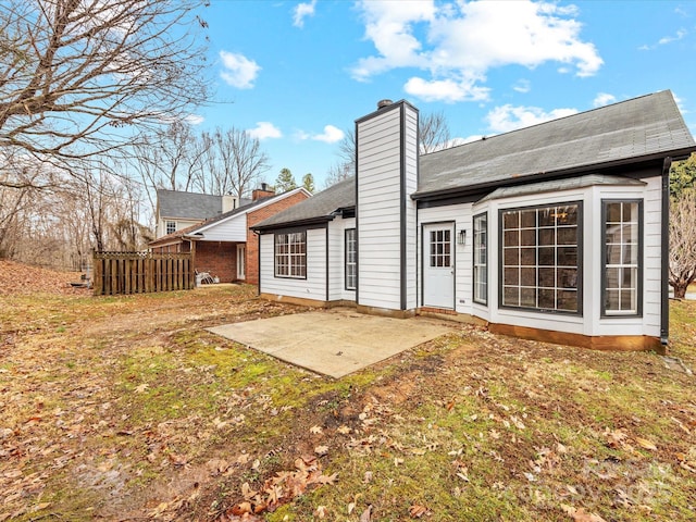 rear view of property featuring a yard and a patio