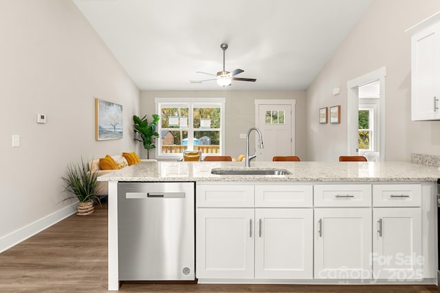 kitchen featuring white cabinetry, dishwasher, light stone countertops, and sink