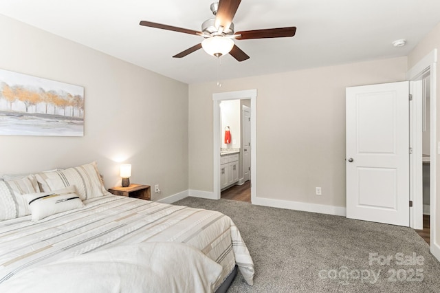 bedroom featuring dark colored carpet, ensuite bath, and ceiling fan