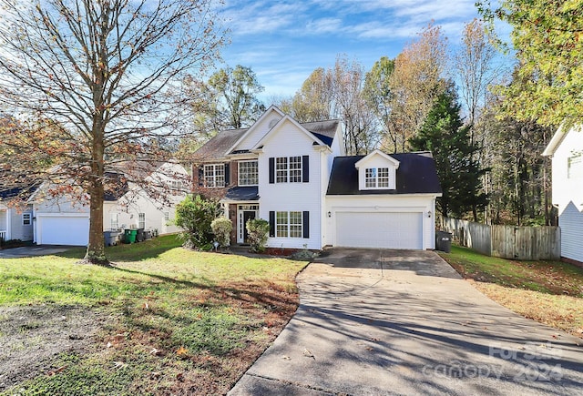 view of front of house featuring a garage and a front lawn