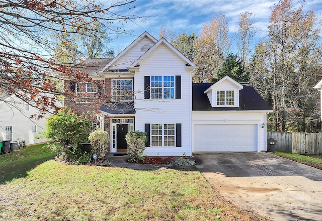 view of front property featuring a front yard and a garage