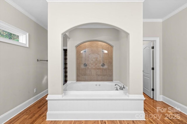 bathroom featuring a bathing tub, hardwood / wood-style floors, and ornamental molding