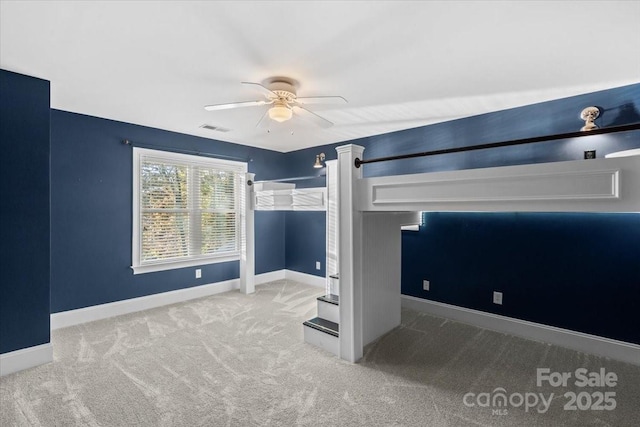 unfurnished bedroom featuring carpet and ceiling fan