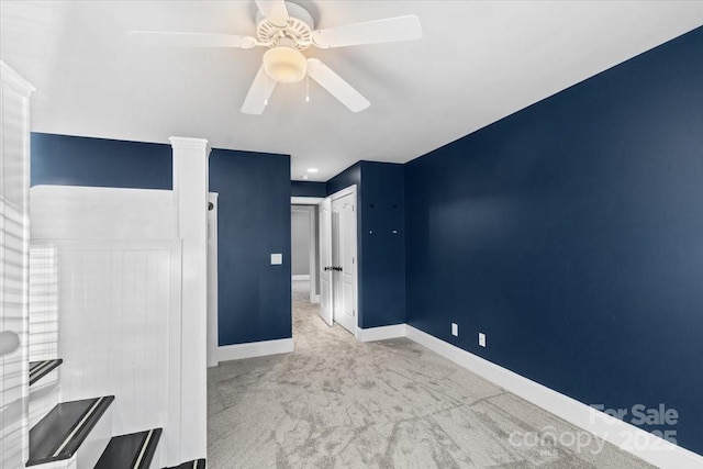 unfurnished bedroom featuring a closet, light colored carpet, and ceiling fan