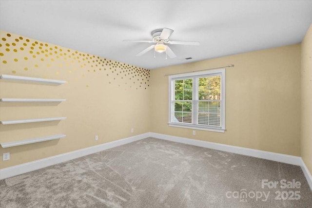 spare room featuring carpet flooring and ceiling fan