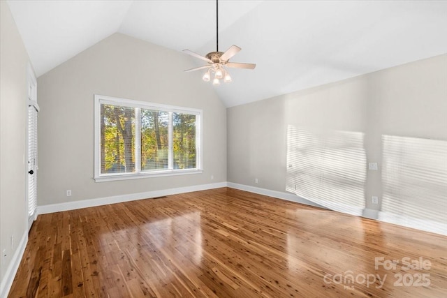 unfurnished room featuring ceiling fan, lofted ceiling, and hardwood / wood-style flooring