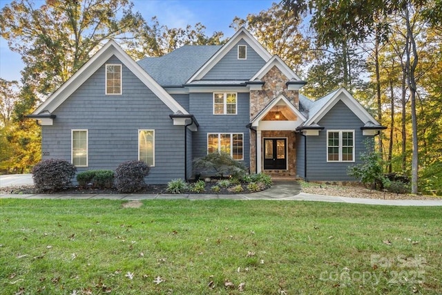 view of front of house with stone siding and a front yard