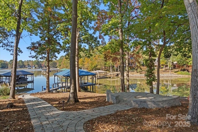 dock area with a water view and boat lift