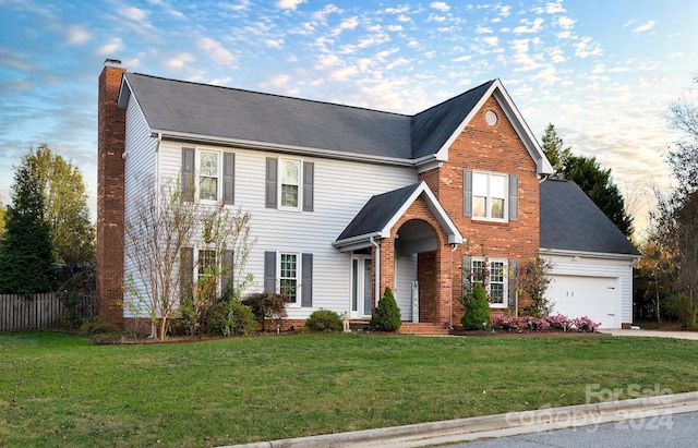 view of front of house featuring a front yard and a garage