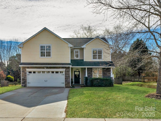 view of property with a garage and a front yard