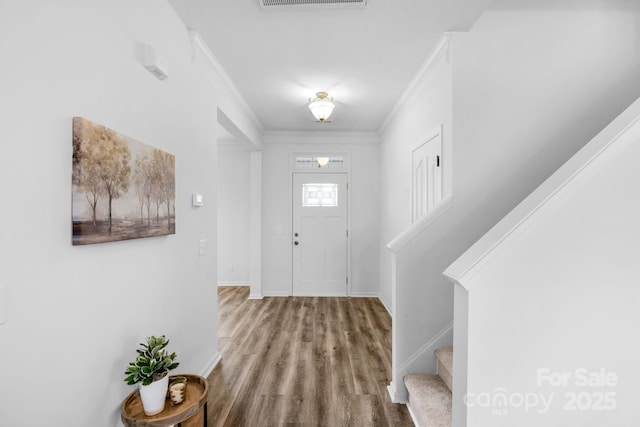 foyer with hardwood / wood-style floors and ornamental molding