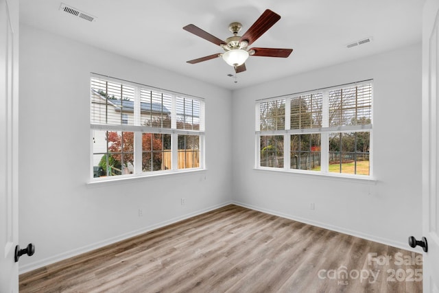 empty room featuring ceiling fan and light hardwood / wood-style floors