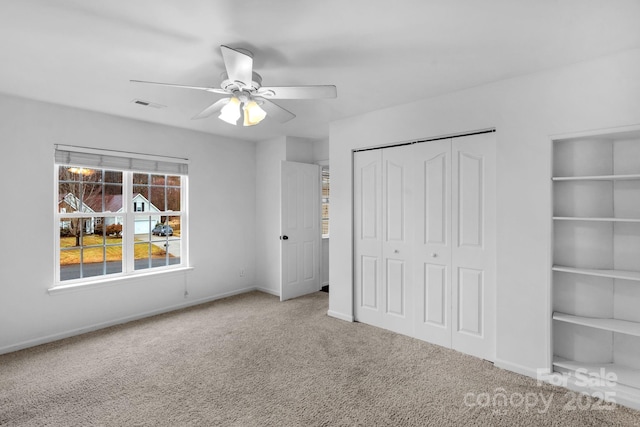 unfurnished bedroom featuring a closet, ceiling fan, and carpet flooring