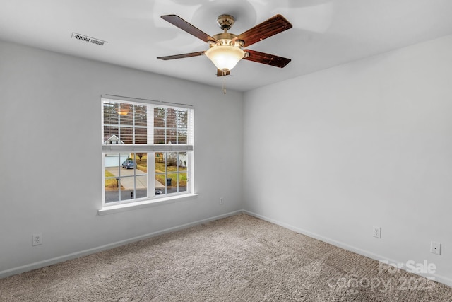 empty room with ceiling fan and carpet