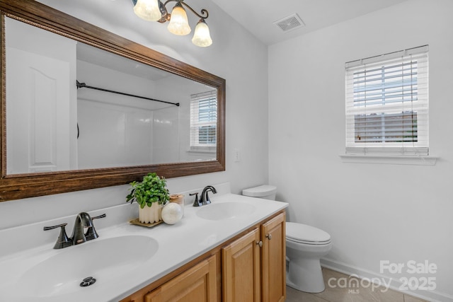 bathroom with vanity, toilet, and tile patterned flooring