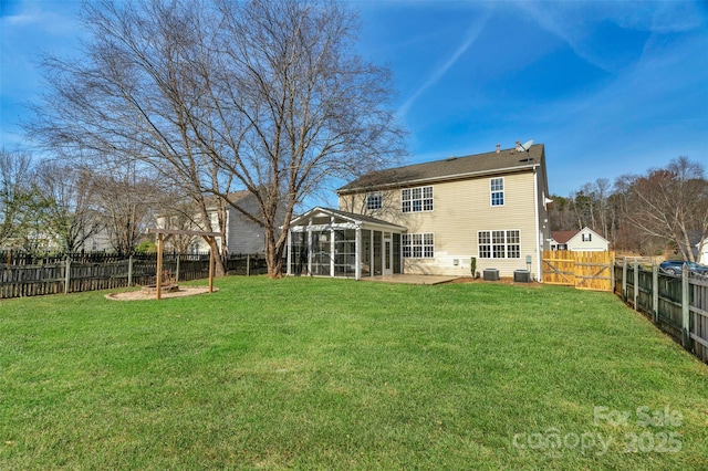 back of house featuring a patio, a sunroom, and a yard