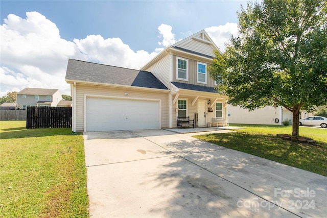 view of front of home featuring covered porch, a garage, and a front yard