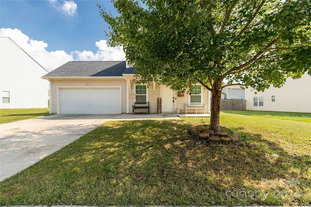 view of front of home with a garage and a front yard