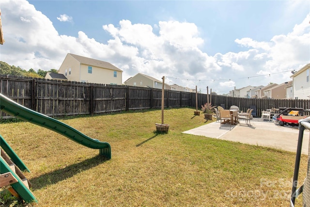 view of yard with a patio area and a playground