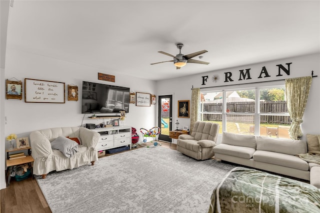 living room featuring ceiling fan and hardwood / wood-style flooring