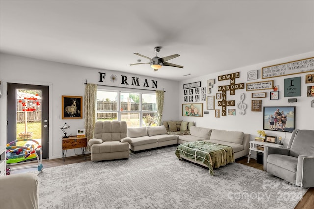 living room with ceiling fan and wood-type flooring