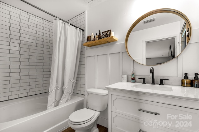 full bathroom featuring vanity, toilet, and shower / tub combo with curtain