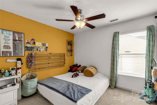 bedroom with light carpet and ceiling fan