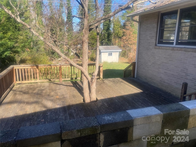 wooden terrace with a storage shed