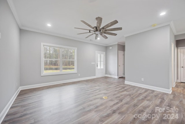 empty room featuring light hardwood / wood-style flooring, ceiling fan, and ornamental molding