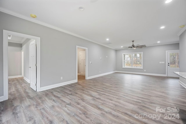 unfurnished living room featuring light hardwood / wood-style flooring, ceiling fan, and crown molding