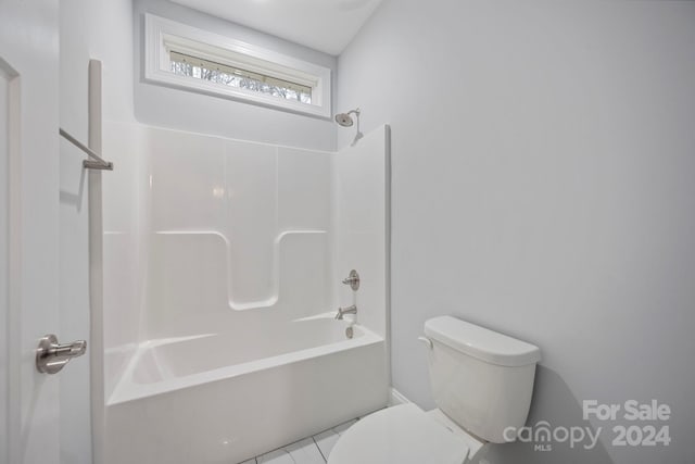 bathroom featuring toilet, shower / bathing tub combination, and tile patterned floors