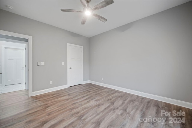 empty room featuring ceiling fan and light wood-type flooring