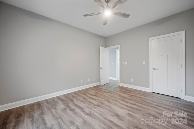 unfurnished bedroom featuring light wood-type flooring and ceiling fan