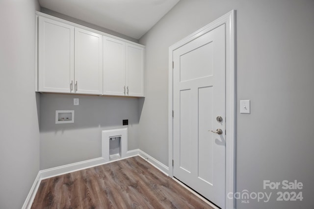 laundry area featuring hookup for an electric dryer, hookup for a washing machine, cabinets, and light hardwood / wood-style floors